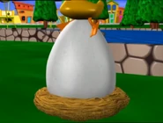 Duck sitting on a giant egg it laid