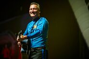 Anthony playing his blue Maton acoustic guitar in "Ready, Steady, Wiggle! Tour"