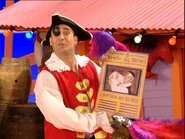 Captain Feathersword holding a newspaper about his nephew, Captain No-Beard