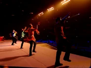 Ben, Larissa, Brett, Anthony and Greg standing on one foot and shaking their hands