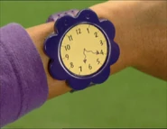 and looks at his watch.