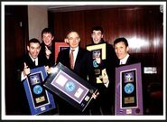 The Wiggles and Bob Carr holding the album awards