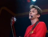 Murray playing the red Takamine Acoustic EF325SRC guitar