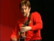 Murray playing red Takamine acoustic guitar