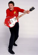 Murray playing his red Maton electric guitar