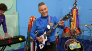 Anthony playing his blue Maton electric guitar in Wiggle Town!