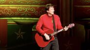 Murray playing his red Maton acoustic guitar in "The Wiggles' Big Big Show!"