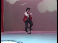 Captain Feathersword riding on unicycle.