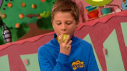 Little Anthony eating the third apple