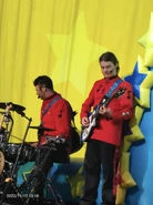 The pants being worn separately by backing musician Jake Cropley during a live concert in 2022.