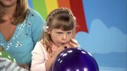 Sophia blowing balloon