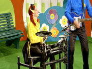 Emma playing the drum set in Wiggly Showtime!