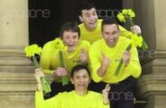 The Wiggles holding yellow daffodils