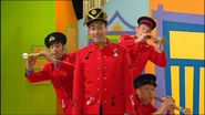 The Wiggles in the red jackets during the music video for "Hats".