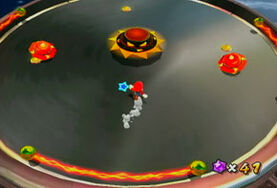 Mario battles Topmaniac with his minions surrounding him: 2 Spiky Topmen, two Micro Topmen.