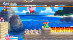 Kirby clings over some Spike (obstacle)s in Onion Ocean. A Glunk is on a platform. To the right of the Glunk are the molten type of Elemental Blocks.