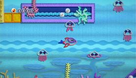 Dolphin Kirby swims past some Jelly Jr.s in Blub Blub Ocean of Water Land.