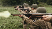 Men firing the Thompson at the range during Part 1 of the series