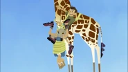 Chris and Martin are tangled now: Martin is wrapped by the measuring tape. Chris can now scan the neck of the giraffe Martin names Necktie now.