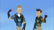 The Kratt brothers are holding Crocodile (Chris) and Hippo (Martin) Power Discs.