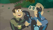 Chris wants to look through the binoculars Martin is looking through because he wants to see the spider monkey too.