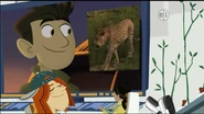 Aviva showing Chris an image of a leopard while Jimmy is sleeping at his desk