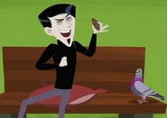 Zach laughing at a pigeon while holding a cookie