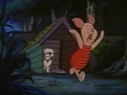 Piglet running in horror away from the believed to be Skippy the sheepdog and his doghouse