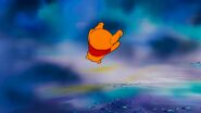 Pooh flies through the air until he arrives in the land of Heffalumps and Woozles.