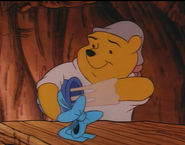 Winnie the Pooh is pulling out glue in his honey pot