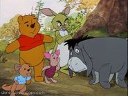 Pooh and his friends looking at Tigger