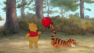 Winnie the Pooh tells Tigger the red balloon wants to stick with him