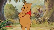 Winnie the Pooh folds his arms
