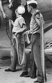 US Navy personnel loading .30-06 belts into an SBD-3, Naval Air Station Norfolk, VA, 1942