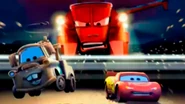 Mater and McQueen running from Frank in a Cars: The Videogame loading screen