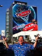 John Lasseter in front of a building advertisement in Los Angeles.
