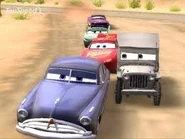 Doc Hudson, Lightning McQueen, Sarge, Flo and Ramone racing.