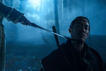 Nynaeve (offscreen) holds a trolloc sword to Lan's throat