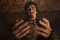 Mat looks down at his hands