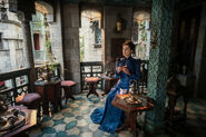 Moiraine drinks tea across from the Light's Blessing Inn