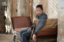 Episode 202: Lan heavily sits on a sofa at Verin's house, recovering after his fight with the Fades