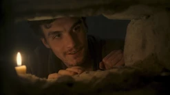 Episode 202: Mat smiles through the opening in the stone wall of his cell