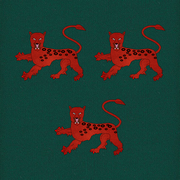 Two red leopards on a field of green