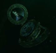 The compass falls to the bottom of the sea.