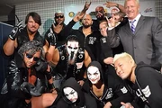 The group pose and celebrate backstage in 2015.
