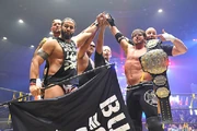 Bullet Club alongside  celebrating a victory.