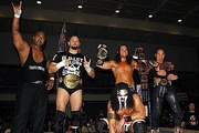 Bullet Club pose after their first match without  in 2015.
