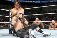 Styles puts Amore in a headlock