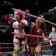 Asuka push onto the turnbuckle