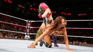 Asuka traps Emma in the ankle lock